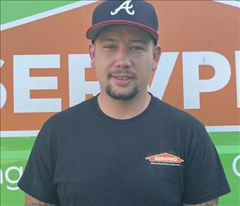 clay (a man) standing in front of green SERVPRO  van as background